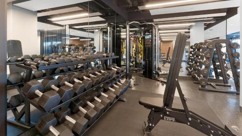 a gym with rows of treadmills and machines at Landing Stunning 2BD Pool Courtyard in Washington