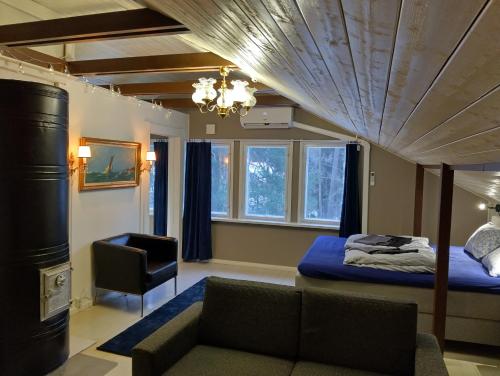 a living room with a bed and a couch at Navy Condo for 6, free parking in Turku