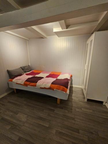 a bedroom with a bed with a colorful comforter at Salhusvegen in Bergen