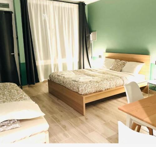 a bedroom with a bed and a table with a tableablish at Mini alloggi alle terme in Abano Terme