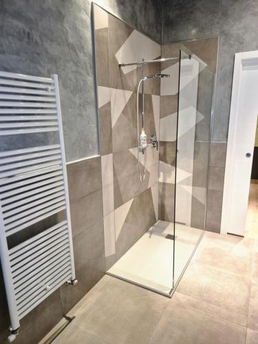 a shower with a glass door in a bathroom at Mini alloggi alle terme in Abano Terme