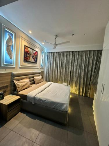 a bedroom with a large bed and a window at Landin2home studios in New Delhi