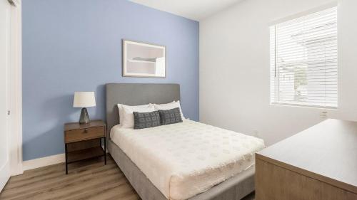 a small bedroom with a bed and a window at Landing Incredible 2BD Gym in Phoenix