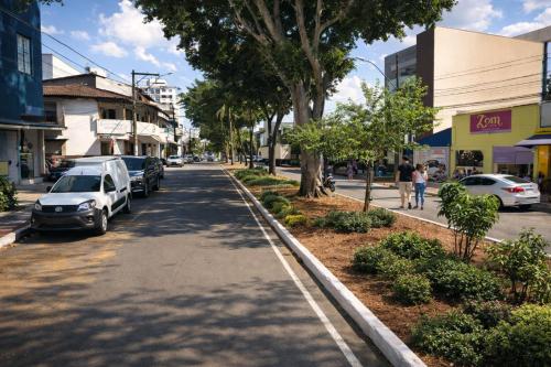 a street with cars parked on the side of the road at Copacabana Stay in Serra