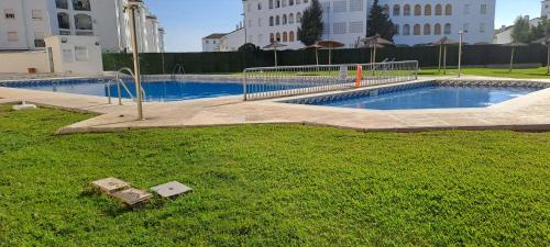 an empty swimming pool in the middle of a city at Apartamento acogedor El portil in El Portil