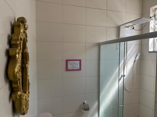 a shower with a glass door in a bathroom at Hostel Casinha Tropical in Rio de Janeiro