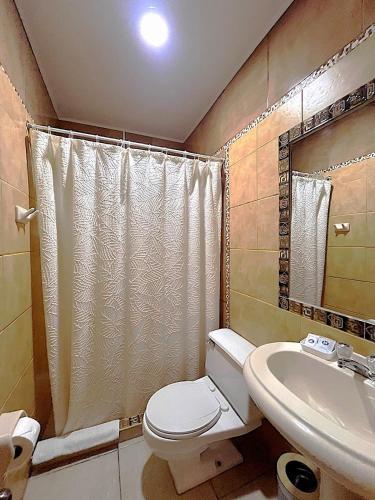 a bathroom with a toilet and a sink at Terra Sagrada Cusco in Cusco