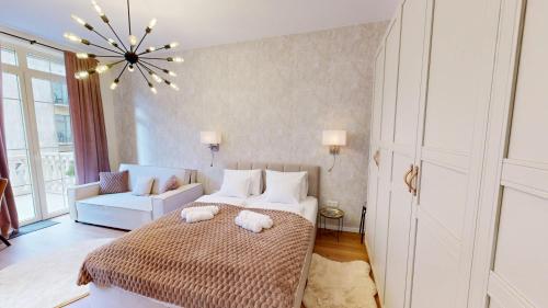a bedroom with a bed and a chandelier at White Lotus Hévíz - 50 m from Thermal Lake in Hévíz