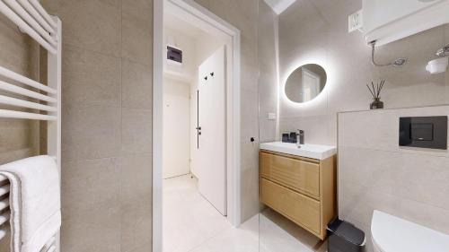 a bathroom with a sink and a mirror at White Lotus Hévíz - 50 m from Thermal Lake in Hévíz
