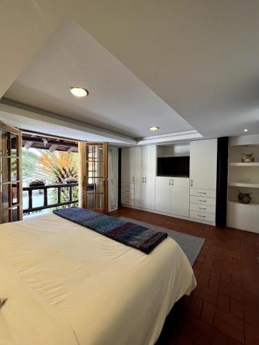 a bedroom with a large bed and a television at Modern Apartment with Private Balcony in Quito
