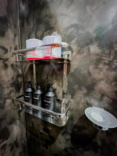 a shelf with a bunch of bottles on it at Lagoon View Mawella Villa in Tangalle