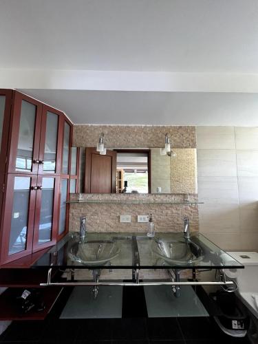 a bathroom with two sinks and a mirror at Modern Apartment with Private Balcony in Quito