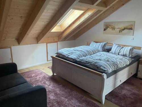 a bedroom with a large bed in a attic at Bordinghouse Arndt in Memmingen