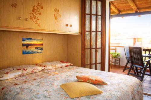 a bedroom with a bed with pillows on it at Casa Vacanze Paola 2 in Santa Luria