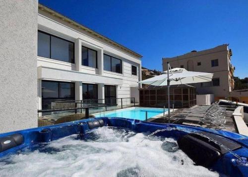 a swimming pool in front of a house at ממלכת החלומות - וילה מהממת עם בריכה פרטית מחוממת מקורה ונוף מהמם in ‘Ein el Asad