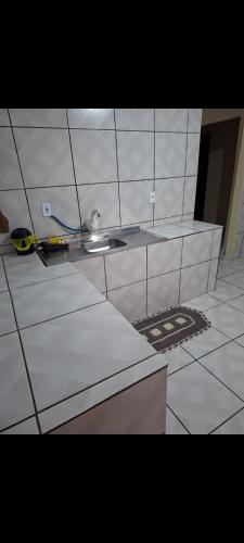 a kitchen with a sink and a counter top at Sitio4meninos in Pinheiral