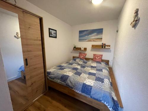 a bedroom with a bed and a wooden door at Kleines Glück Grömitz in Grömitz