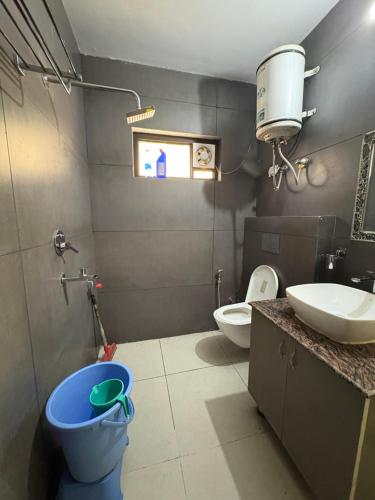 a bathroom with a toilet and a sink at Namya Villas in Bhīm Tāl