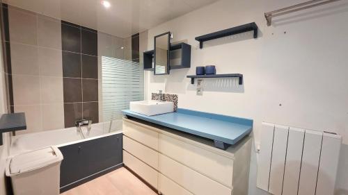 a bathroom with a sink and a toilet at Le Grand Minck in Grand-Fort-Philippe