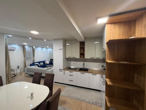 a kitchen and living room with a table and a couch at Stan na dan Jelah in Jelah