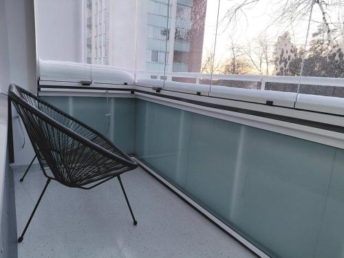 a bench sitting in front of a window at Cozy studio near the train station in Lappeenranta