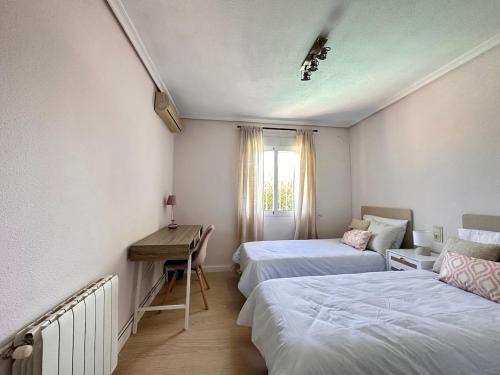 a room with two beds and a desk in it at Casa Mar in Valencia