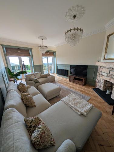 a living room with a couch and a fireplace at Gower view in Burry Port