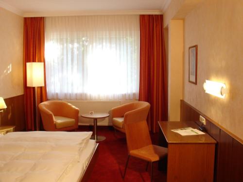 a hotel room with a bed and a table and chairs at Klaus im Weinviertel in Wolkersdorf
