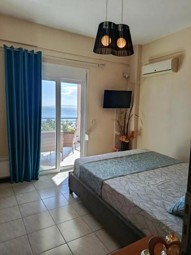 a bedroom with a bed and a view of the ocean at Thalassa in Panayía