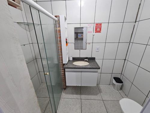 a small bathroom with a sink and a toilet at São Luís Hostel - Dormitórios Compartilhados e Quartos Privativos in São Luís