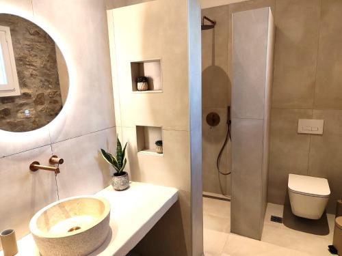 a bathroom with a sink and a shower at Megusta Mykonos in Tourlos