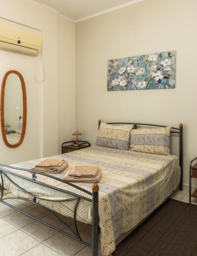 a bedroom with a bed and a mirror at Central Cozy Apartment in Sparta