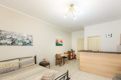 a living room with a bed and a table at Central Cozy Apartment in Sparta