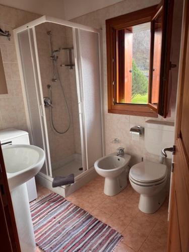 a bathroom with a sink and a toilet and a shower at Cà de l'Angel in Torre di Santa Maria