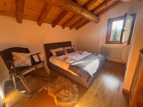 a bedroom with a bed and a chair in it at Cà de l'Angel in Torre di Santa Maria