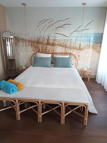 a bedroom with a large bed with blue pillows at La Tour Jayan in Agen