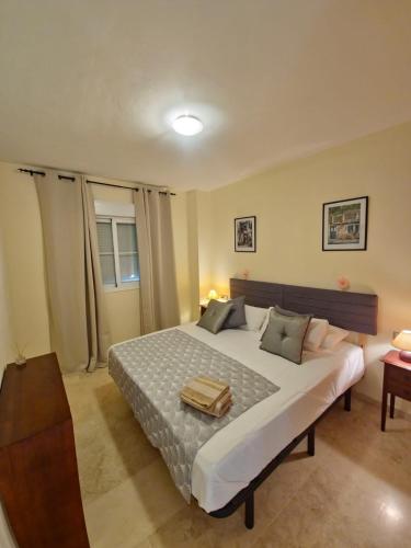 a bedroom with a large bed in a room at Apartamentos Residencial Duquesa in San Luis de Sabinillas
