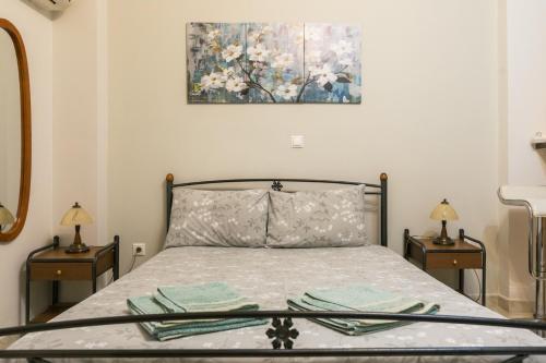a bedroom with a bed with two nightstands and a painting at Central Cozy Apartment 4 in Sparta