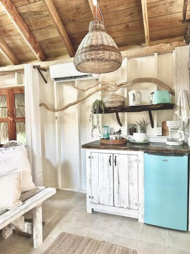 a kitchen with a blue refrigerator and a table at Shipwreck Cove in Caye Caulker
