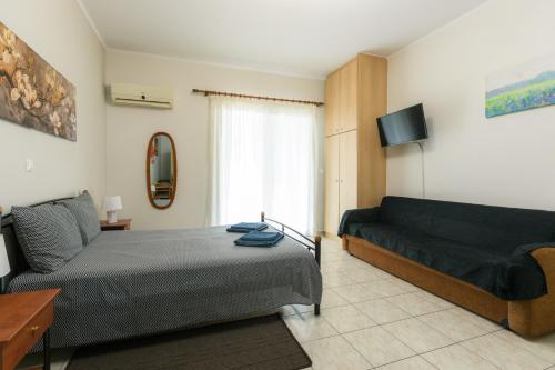 a bedroom with a bed and a couch at Central Cozy Apartment 3 in Sparta