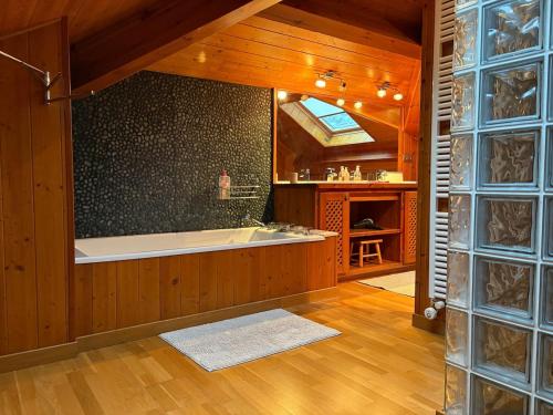 a large bathroom with a bath tub in a room at Les Bosquitos Chalet in Ax-les-Thermes