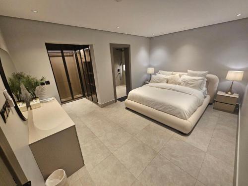 a bedroom with a bed and a table and a desk at شقق باطلالات بانوراميه in Riyadh
