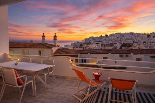a balcony with a table and chairs and a view of a city at Ocean Balcony apartment terrace sea view and pool in Albufeira
