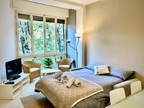 a bedroom with a bed and a large window at Anna Home Gallarate train station to Milan Malpensa self-check-in in Gallarate