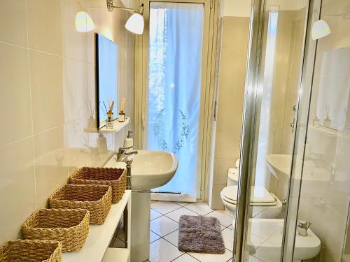 a bathroom with a sink and a toilet and a shower at Anna Home Gallarate train station to Milan Malpensa self-check-in in Gallarate