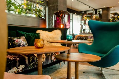 a couple of tables and chairs in a restaurant at Motel One Salzburg-Süd in Salzburg