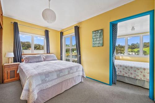 a bedroom with a bed and a large window at The Castle in Baylys Beach