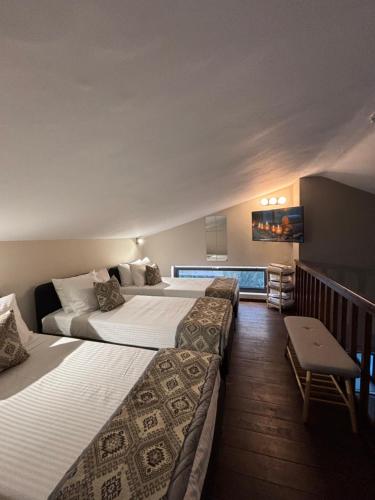 two beds in a hotel room next to a balcony at Cretan stars villas Hersonissos in Hersonissos