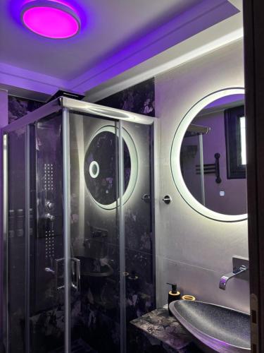 a bathroom with a walk in shower and a mirror at Cretan stars villas Hersonissos in Hersonissos