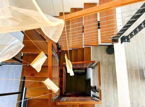 a spiral staircase in a building with wooden steps at Casa Solana in Puntarenas